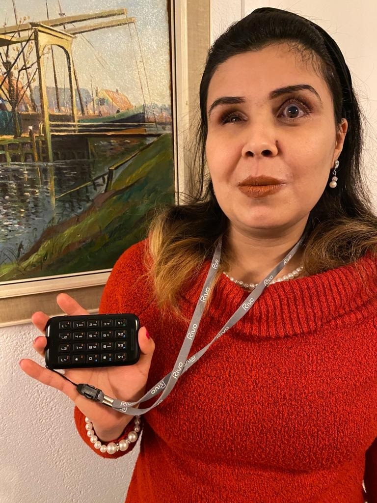 woman holding Rivo2 smartphone companion for the blind
